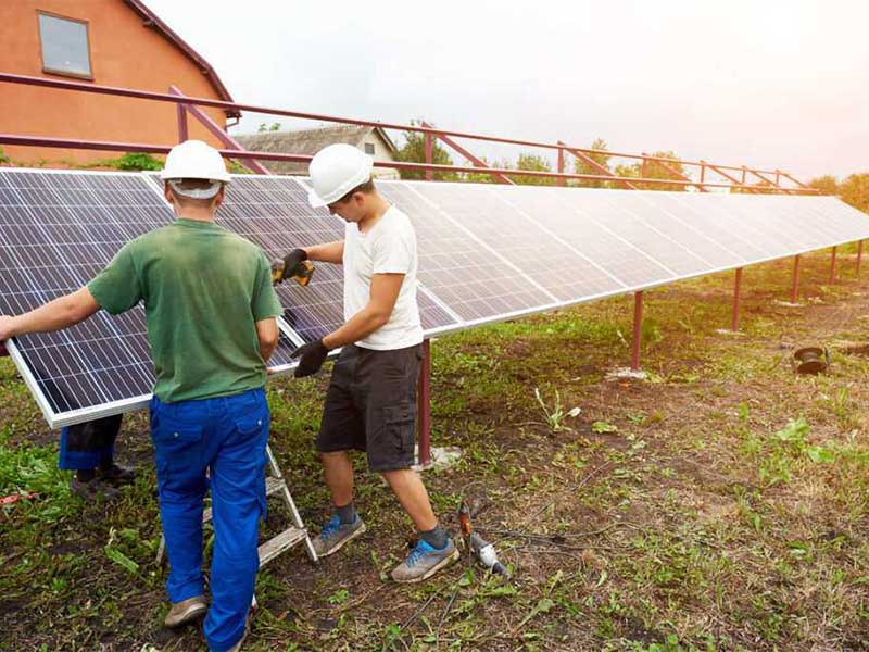 two people installing solar panels