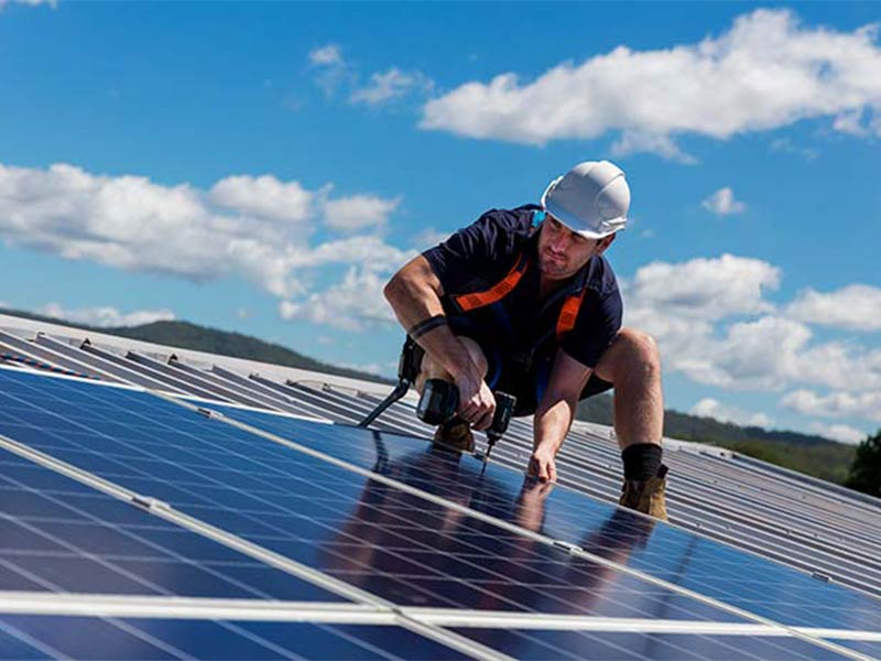man installing a solar panel
