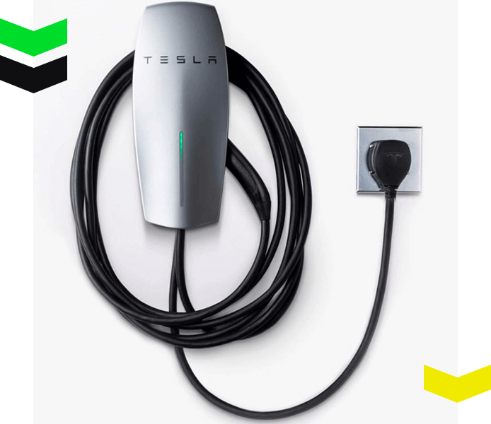 A Wall-mounted Tesla EV charger plugged into an outlet with a coiled cable, shown in Chicago, IL.
