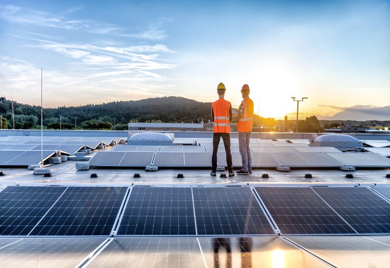 A solar-powered home glows warmly after sunset, thanks to rooftop solar panels in Chicago, IL