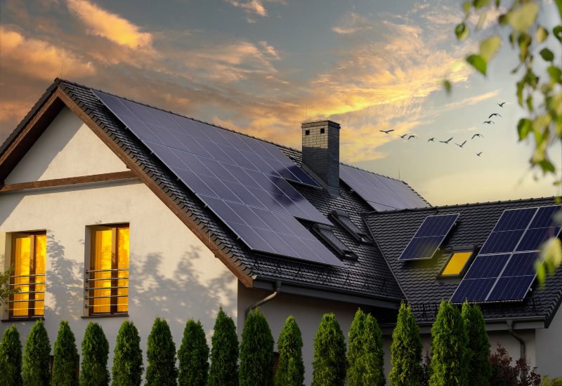 A solar-powered home glows warmly after sunset, thanks to rooftop solar panels in Chicago, IL