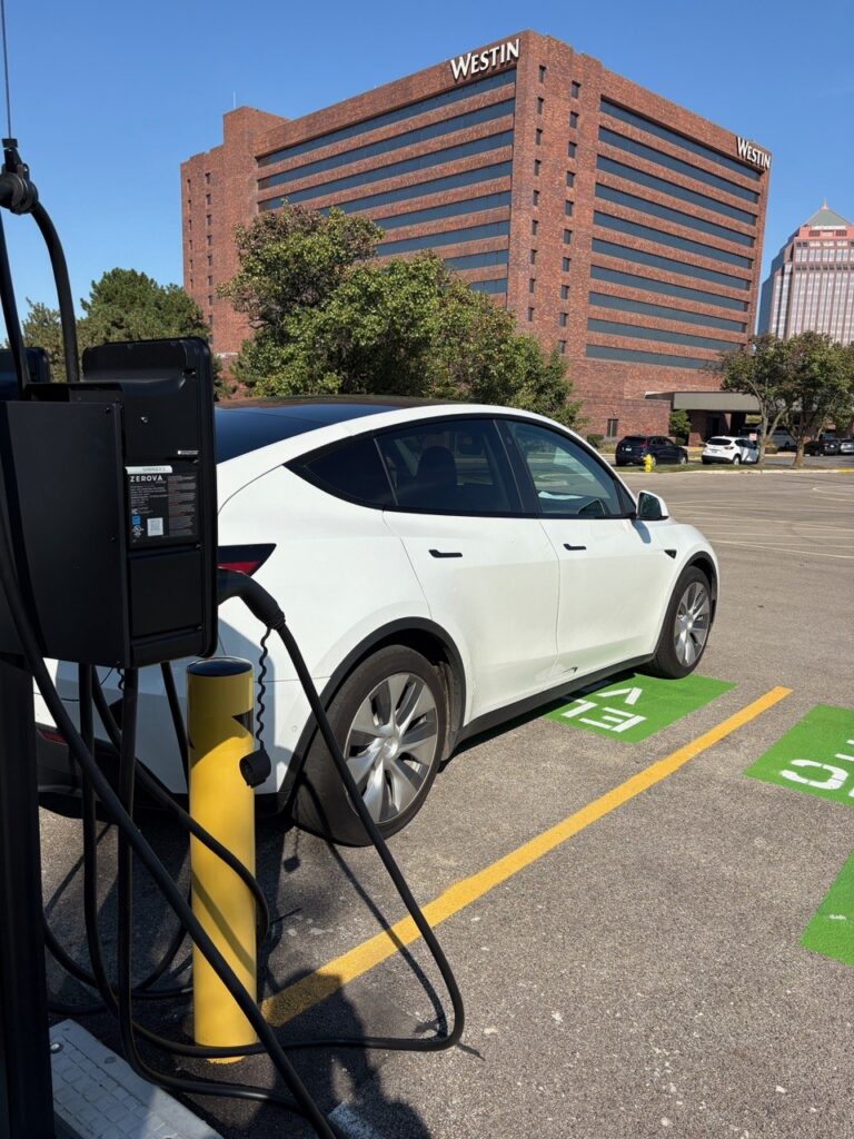A car is charging at the EV station in the Westin hotel parking on a sunny day in Chicago, IL