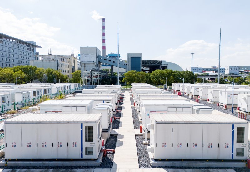 White battery storage containers at a commercial facility with an industrial backdrop in Chicago, IL